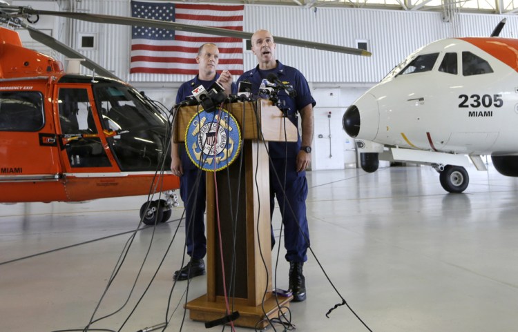 Capt. Mark Fedor, right, chief of response for the Coast Guard 7th District, offers an update on the search for crew members from the missing El Faro, with Lt. Cmdr. Gabe Somma, left, (who grew up in Portland, Maine) on Monday at the Opa-locka Airport in Opa-locka, Fla.
