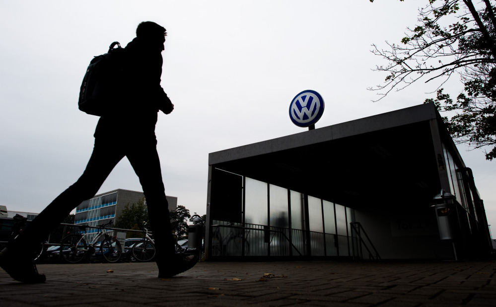 An employee enters the Volkswagen factory site in Wolfsburg, Germany.