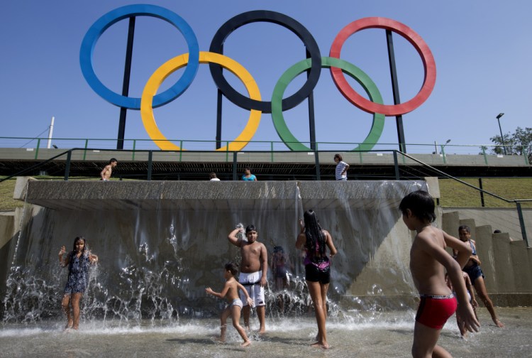 Children play in a water fountain next to Olympic rings in Rio de Janeiro, Brazil, this summer.