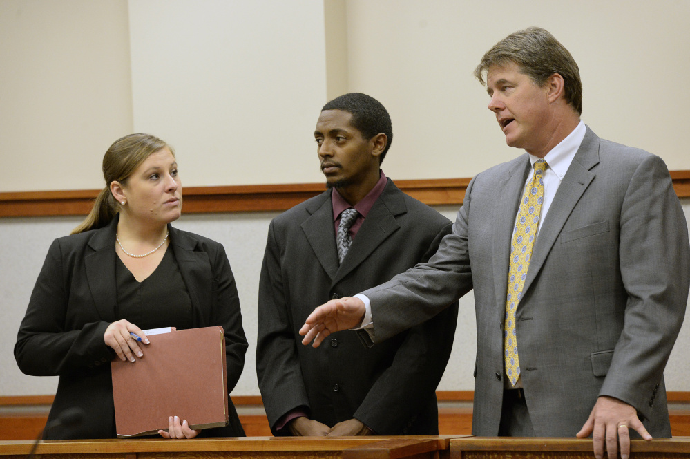 Abil Teshome, center, 23, of Portland, appears in a Cumberland County courtroom with his attorneys Alison Meyers and Jon Gale on Tuesday.