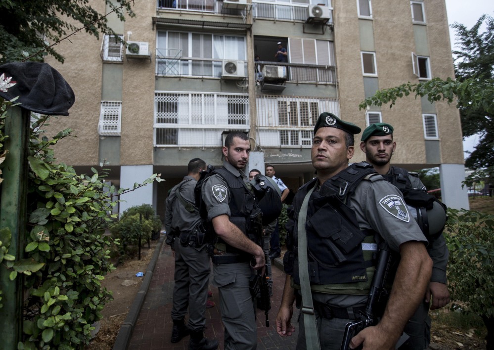 Israeli police stand at the scene of an attack in Kiryat Gat, Israel, on Wednesday. A Palestinian man who stabbed a soldier was shot and killed by Israeli security forces.