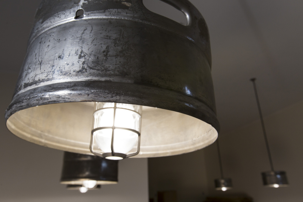 The ceiling fixtures at the Fore River Brewing Co. are made from repurosed beer kegs. Ben McCanna/Staff Photographer