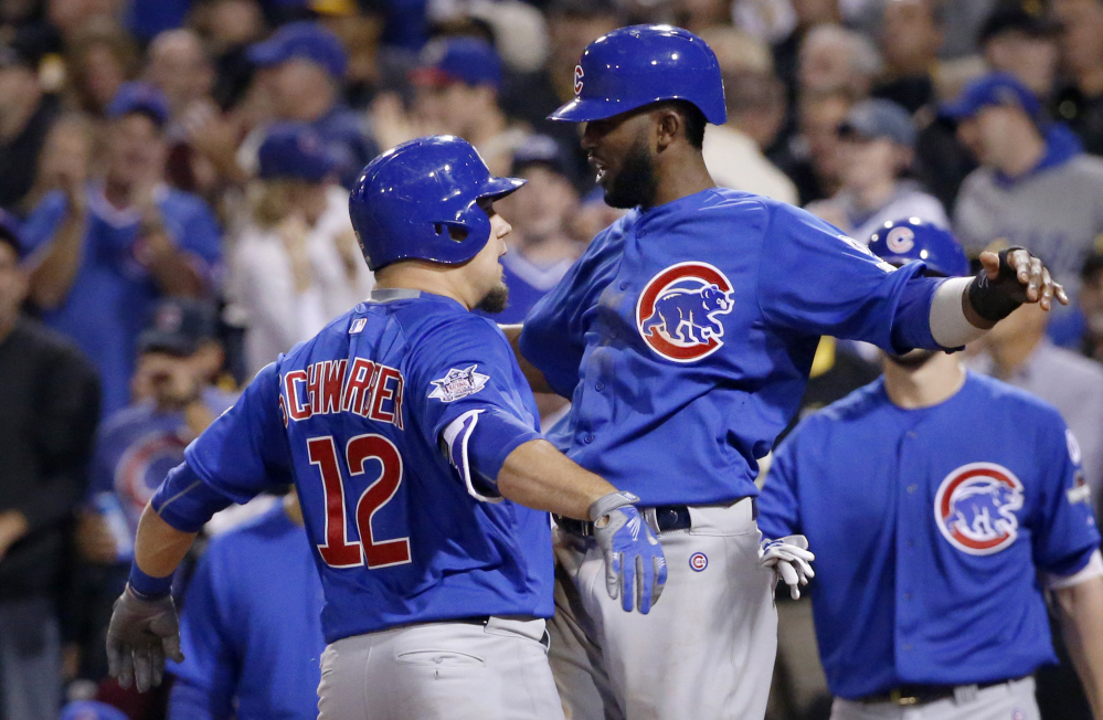 Chicago Cubs Kyle Schwarber (12) and Dexter Fowler celebrate after Schwarber drove in Fowler with a two-run home run in the third inning of Chicago’s 4-0 win.