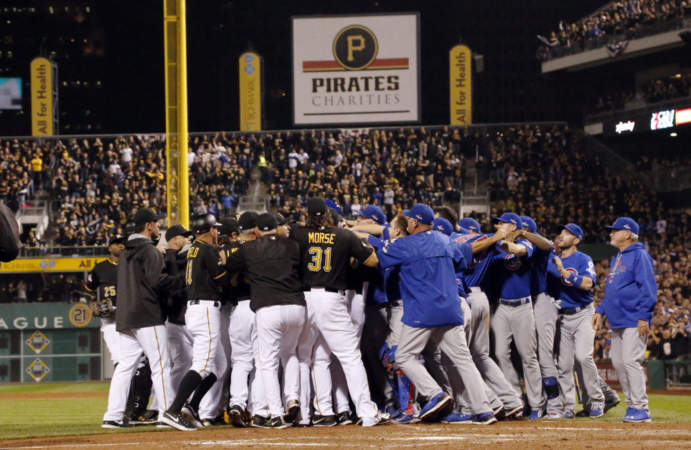 Players from both teams swarm the field after Cubs pitcher Jake Arrieta was hit by a pitch by Pirates relief pitcher Tony Watson in the seventh inning. Arrieta finished the game, completing a four-hit shutout.