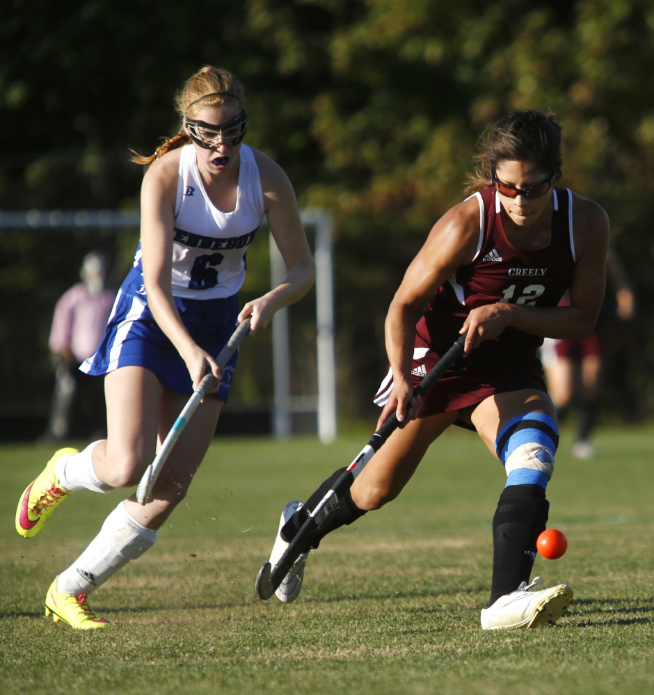 Chloe Smith of Kennebunk, left, moves the ball up the field as Alyssa Coyne of Greely defends during the first half. Derek Davis/Staff Photographer