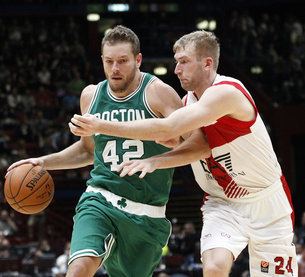 David Lee of the Boston Celtics drives on Olimpia Milano’s Robbie Hummel during a 124-91 win by Boston as part of the NBA Global Games on Tuesday in Assago, Italy. Lee, who won a title with Golden State last season, says his new Boston team has “great chemistry.”