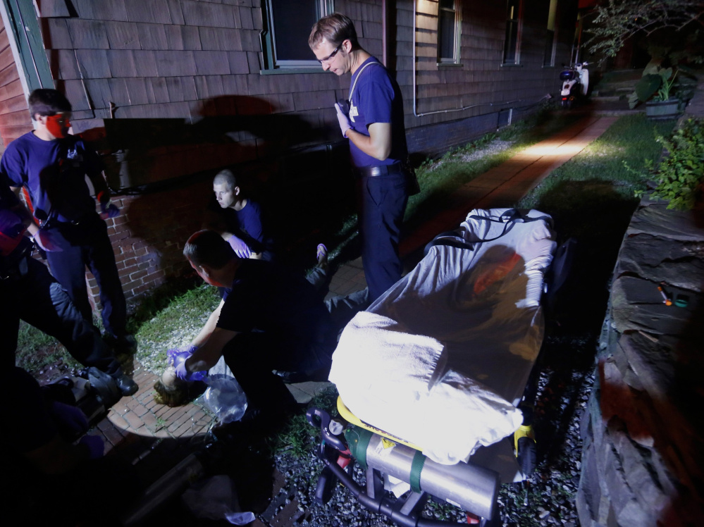 Portland paramedics respond to a call of a heroin overdose on Congress Street in August. Portland Police Chief Michael Sauschuck says that most of the city’s crime has some connection to substance abuse.