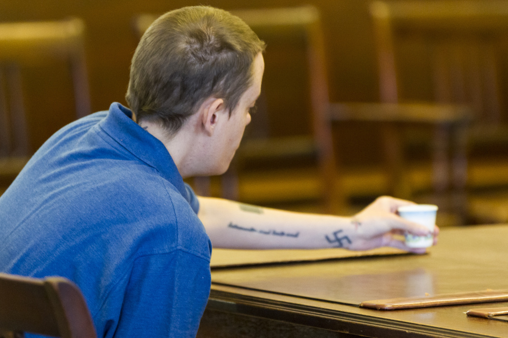 ALFRED, ME - OCTOBER 8: A tattooed swastika is visible on the left arm of Connor MacCalister, 31, of Saco, while she reaches for a drinking cup in the courtroom at York County Court. Connor eventually pleaded guilty of murder in the stabbing death of a woman in a Saco supermarket. (Photo by Ben McCanna/Staff Photographer)