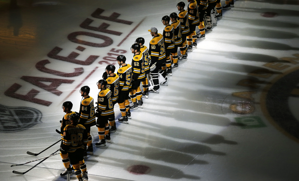 Bruins players line up for introductions before the opening game of the season.
