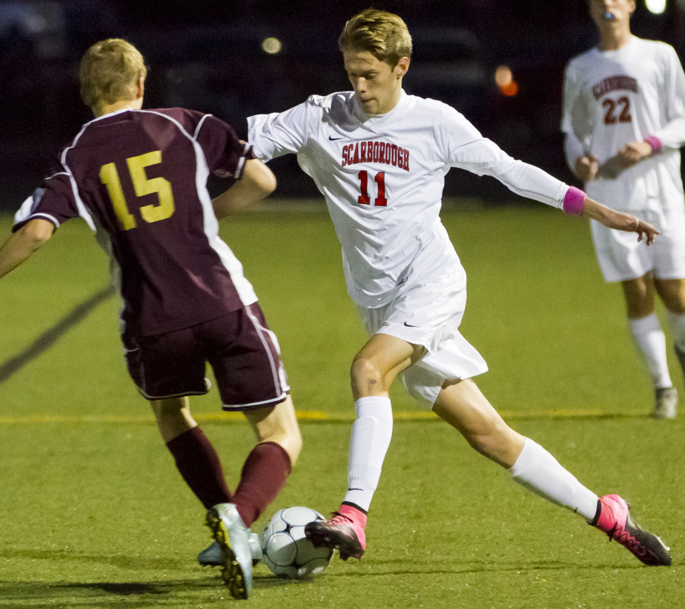 Garrett King, who made the cross that led to the second goal for Scarborough, competes for the ball with Dan Marsh of Thornton Academy.