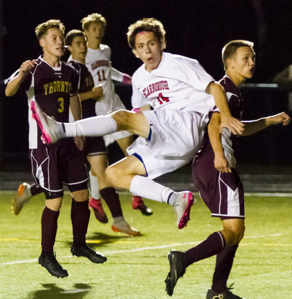 Jake Kacer of Scarborough watches his second-half header sail into the net Thursday night, clinching a 2-0 victory against Thornton Academy. Jacob McGarvey scored in the first half for the Red Storm.
