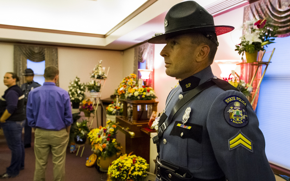 Cpl. Set Edwards, a K9 trainer for the Maine State Police, serves as an honor guard at Fortin Funeral Home on Friday during a wake in memory of Colton Guay. Dozens of law enforcement officers attended the wake for the toddler, whose father, Jon Guay, is a deputy with the Androscoggin County Sheriff’s Office. 
Ben McCanna/Staff Photographer