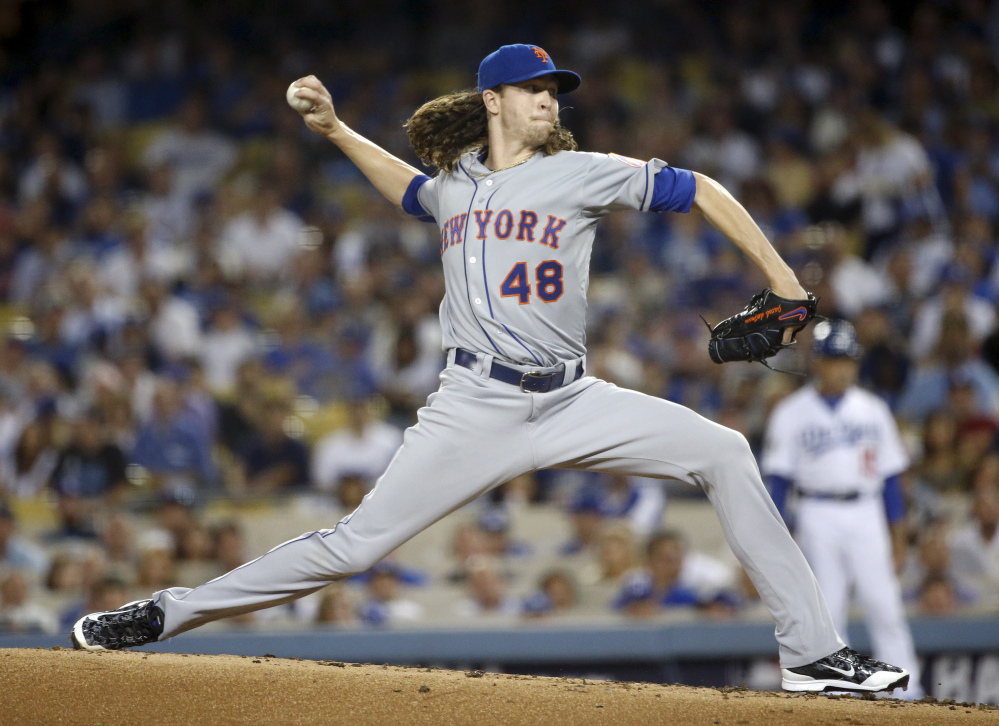 New York Mets starting pitcher Jacob deGrom throws against the Los Angeles Dodgers in the first inning of Friday night’s National League Division Series game in Los Angeles.
