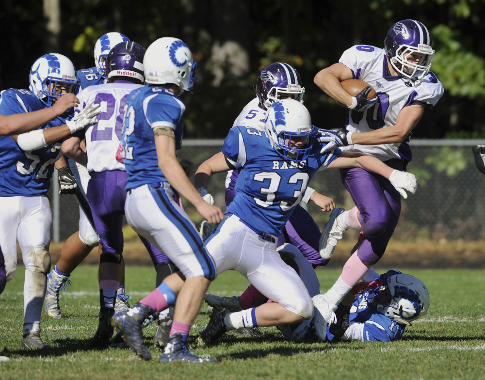 Zach Doyon of Marshwood breaks away from Kennebunk defenders, as he did often on his way to 244 rushing yards and three TDs.