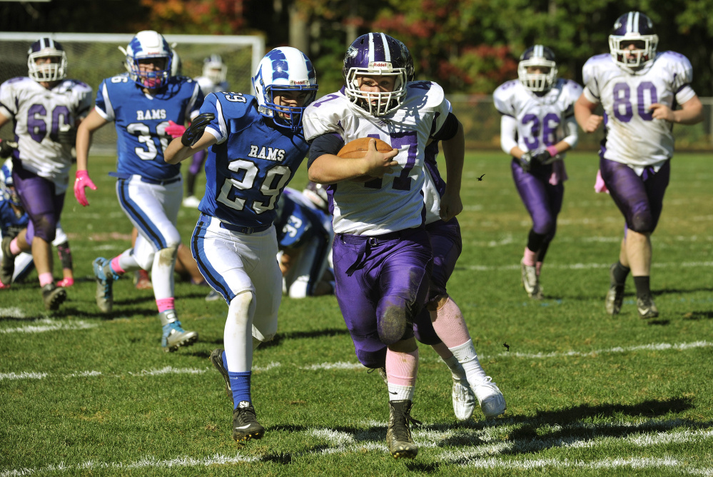 Marshwood fullback Justin Stacy pulls away from the Kennebunk defense on his way to a big gain Saturday. Marshwood is 5-1 after handing Kennebunk its first loss of the season, 61-14.