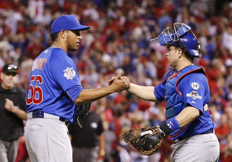 Chicago Cubs' Hector Rondon, left, is congratulated by catcher Miguel Montero after the Cubs defeated the St. Louis Cardinals, 6-3, in Game 2 of the National League Division Series Saturday in St. Louis. The Associated Press