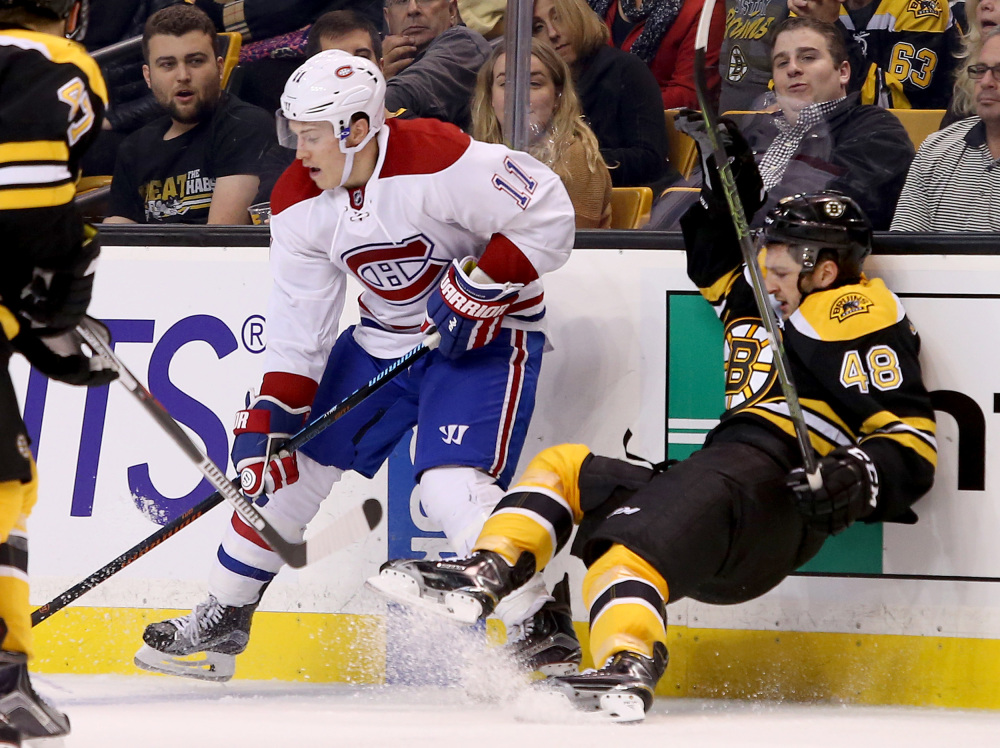 Montreal Canadiens right wing Brendan Gallagher checks Boston Bruins defenseman Colin Miller along the boards in the third period Saturday. The Associated Press