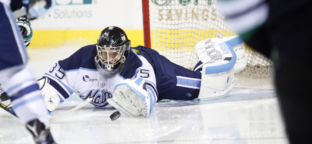 University of Maine goalie Rob McGovern sprawls to make a save in the second period Saturday night. Chris Wilkie scored on the rebound for North Dakota.