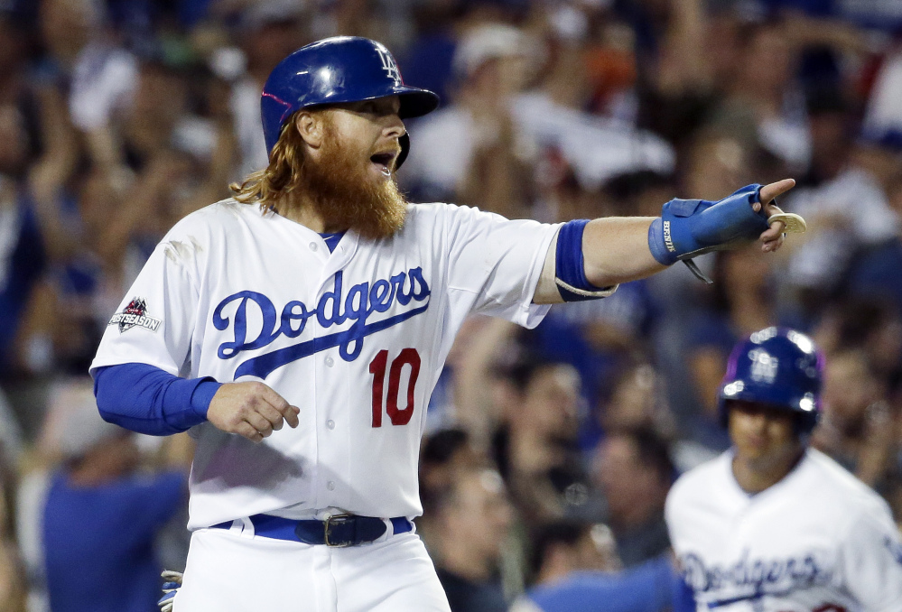 Dodgers’ third basemen Justin Turner celebrates scoring on a double by outfielder Andre Ethier against the Mets in the fourth inning of Game 2 of the National League Division Series on Saturday.