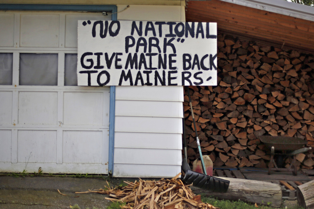 A sign in opposition to a proposed national park is posted on a home in Millinocket.