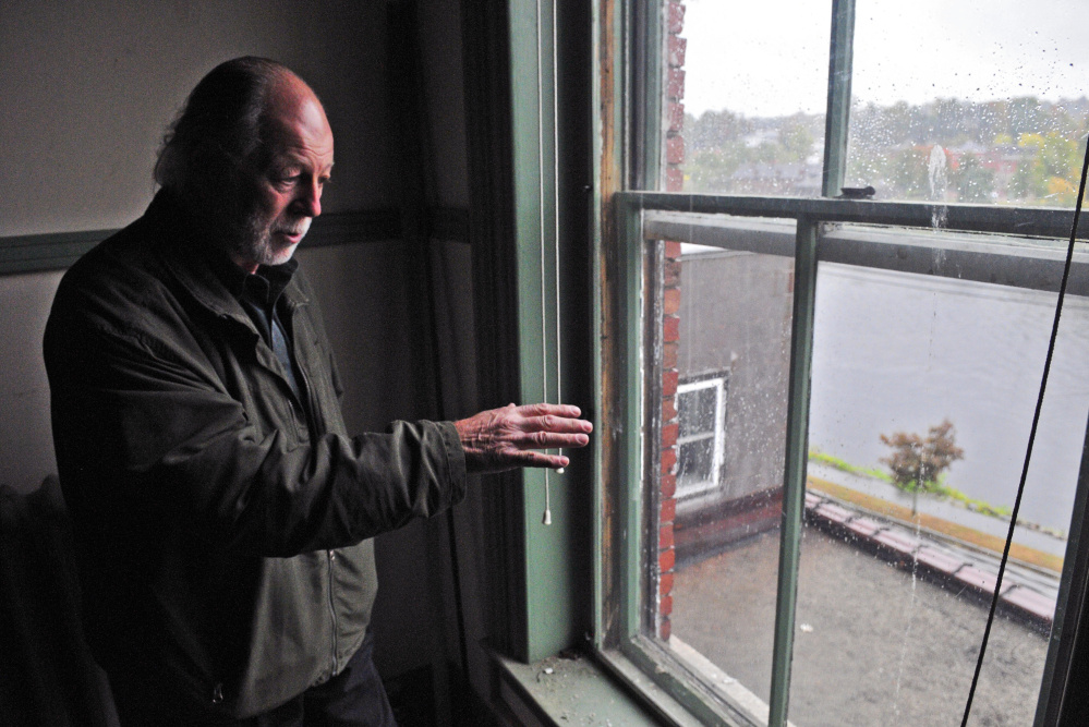 Richard Parkhurst looks at the view of the Kennebec River from a window at 287 Water St. in Augusta.