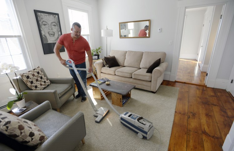 Gary Wagner vacuums the half of his home he rents out on Airbnb after guests had left Thursday. The West End homeowner started listing the space in July, and says it quickly was booked through October. “There’s a clear demand,” he said.