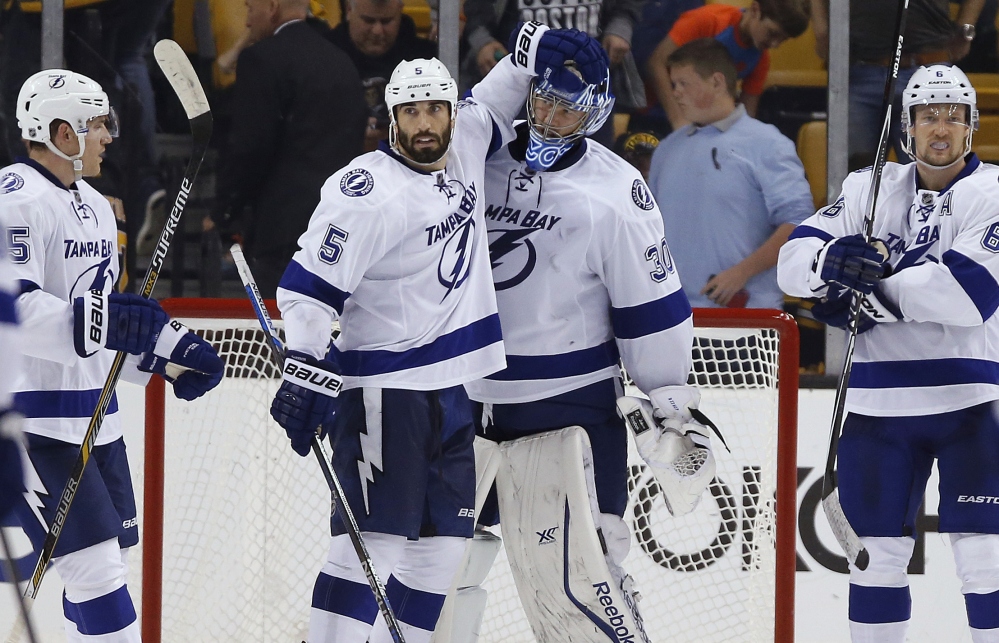 Tampa Bay goalie Ben Bishop and Jason Garrison celebrate their 6-3 win over the Bruins, the Lightning’s first win in Boston in more than five years.