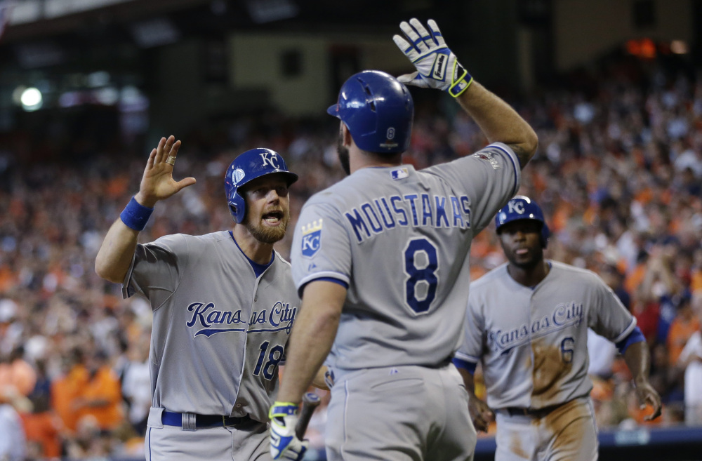 Kansas City’s Ben Zobrist (18) celebrates with teammate Mike Moustakas after he and Lorenzo Cain (6) scored during a five-run rally in the eighth inning of Monday’s American League Division Series game in Houston.