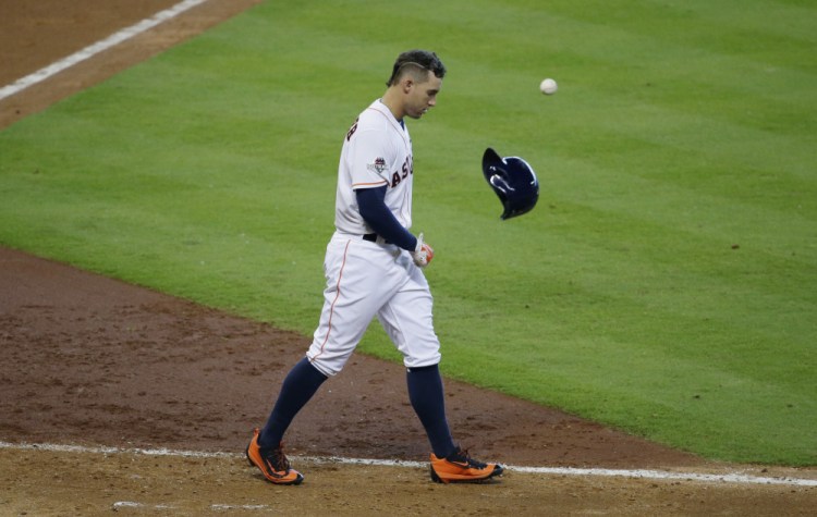 The Astros’ George Springer tosses his helmet after striking out to end the eighth inning. Kansas City went on to win and push the series to a decisive fifth game.