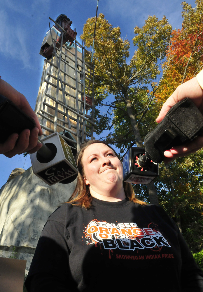 Organizer Jennifer Poirier speaks with the media during a rally of Skowhegan Indian supporters in front of the huge Indian sculpture in Skowhegan on Monday.