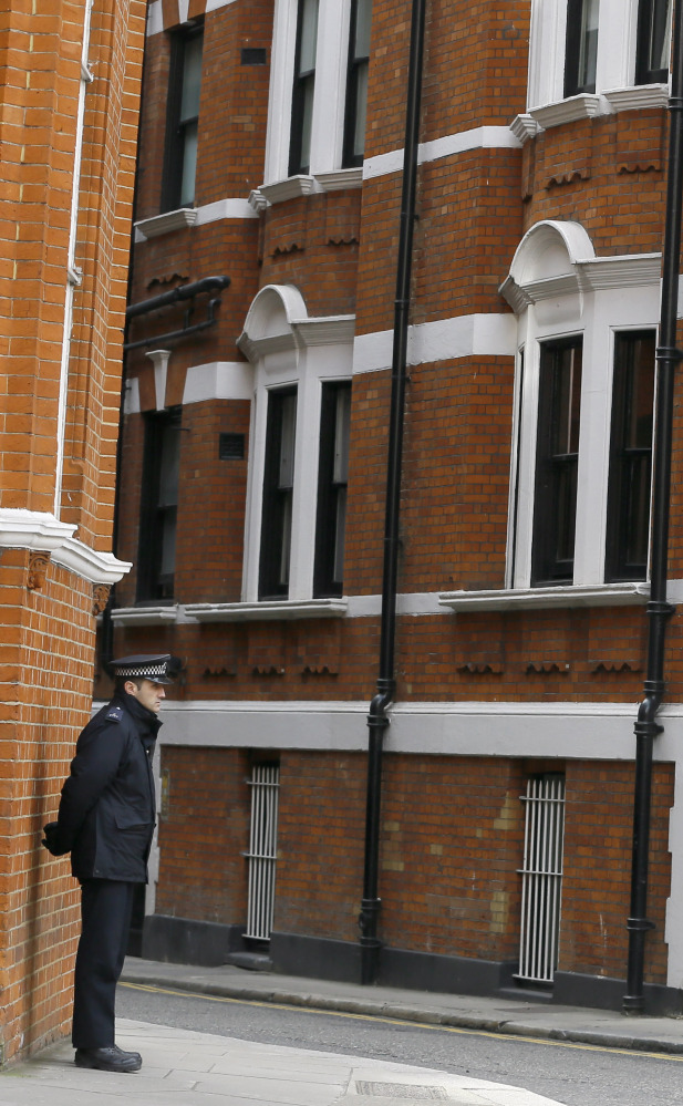 A British police officer stands guard outside the Ecuadorean Embassy in London.