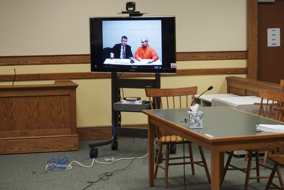 Christopher Hall, right, appears via video link from jail in Springvale District Court with defense attorney Randall Bates for Hall's initial appearance on assault charges for an attack on a lawyer using a cane equipped with a shocking device. Photo by Scott Dolan/Staff Writer