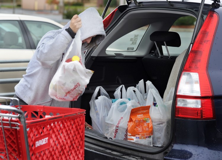 Melody Bertrand of Durham loads her car with plastic bags filled with products from Target at the Topsham Fair Mall. She said she forgot to bring her reusable bags to Target. “I always recycle the plastic bags by bringing them back and putting them into the plastic bag recycle container inside Target,” she said. “They should let people take the merchandise to their cars and put the bags back into the cart to be recycled by the store. The store should make the bags bigger and put more into them,” she said.