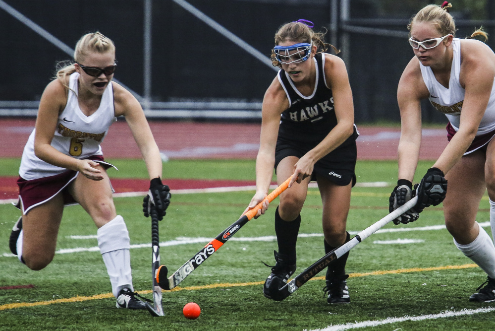 Thornton Academy’s Sidney Hurst, left, and Grace Decker, right ,try to head off Marshwood’s Leah Glidden in Tuesday’s game at Saco. TA won, 1-0.