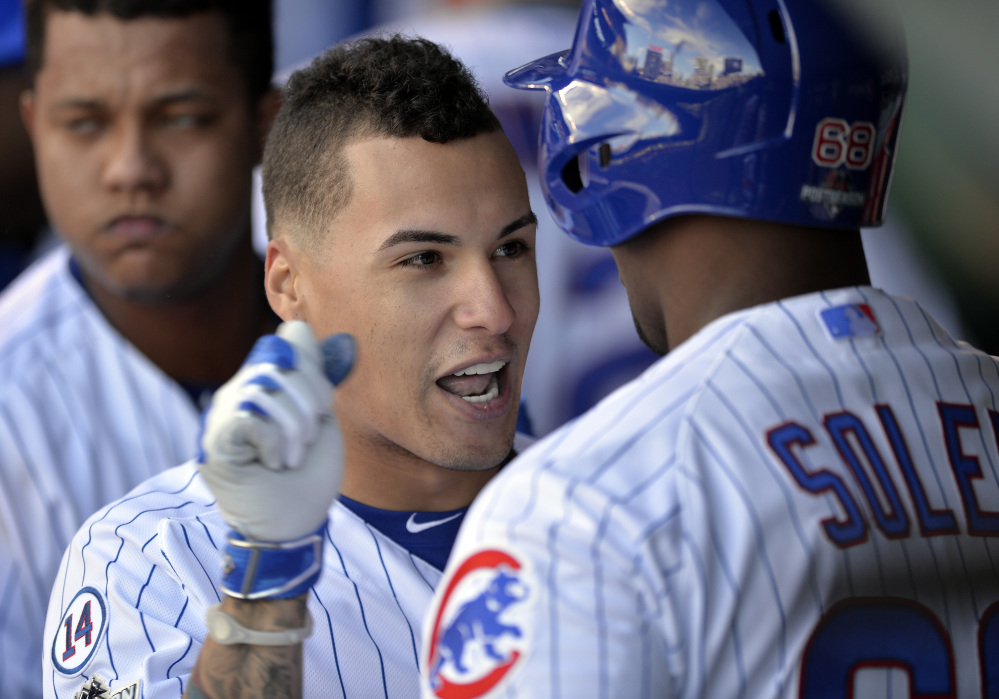 Chicago’s Javier Baez (9) celebrates his three-run home run with Jorge Soler in the second inning, as the Cubs take an early 4-2 lead.
