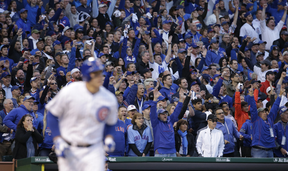 The fans cheer at Wrigley Field as the Cubs’ Anthony Rizzo hits a tie-breaking home run in the sixth inning. The run proved to be the game winner as Chicago won the series over St. Louis, three games to one.