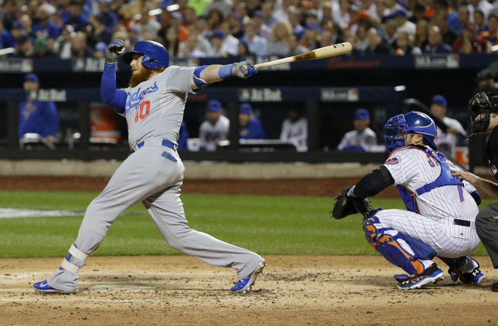 The Dodgers’ Justin Turner follows through on a two-run double to left field in the third inning of Tuesday night’s game. The two runs were all Clayton Kershaw and the Dodgers needed to win and send the National League Division Series to a decisive fifth game.