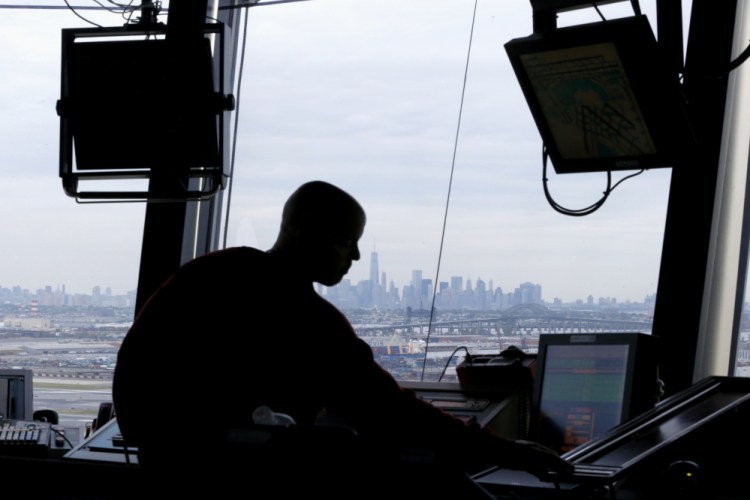 An air traffic controller works in the tower at Newark Liberty International Airport in Newark, N.J.