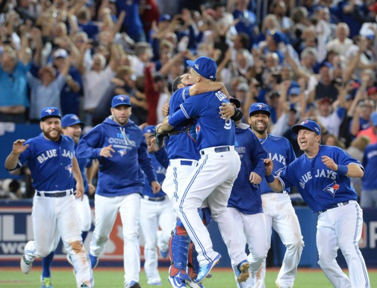 The Toronto Blue Jays celebrate their 6-3 win over Texas in Game 5 of the American League Division Series. The Blue Jays clinched their first trip to the American League Championship Series since 1993.