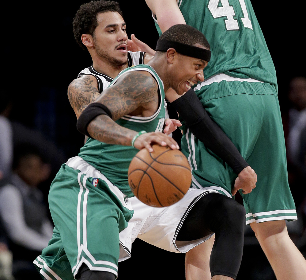 Isaiah Thomas of the Boston Celtics looks to drive against Shane Larkin of the Brooklyn Nets during the second period of Boston’s 109-105 victory in a preseason game Wednesday night. The Celtics will be at the Knicks on Friday night.