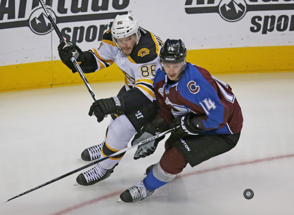 Bruins defenseman Kevan Miller battles with Avalanche left wing Blake Comeau for control of the puck in the first period Wednesday in Denver.