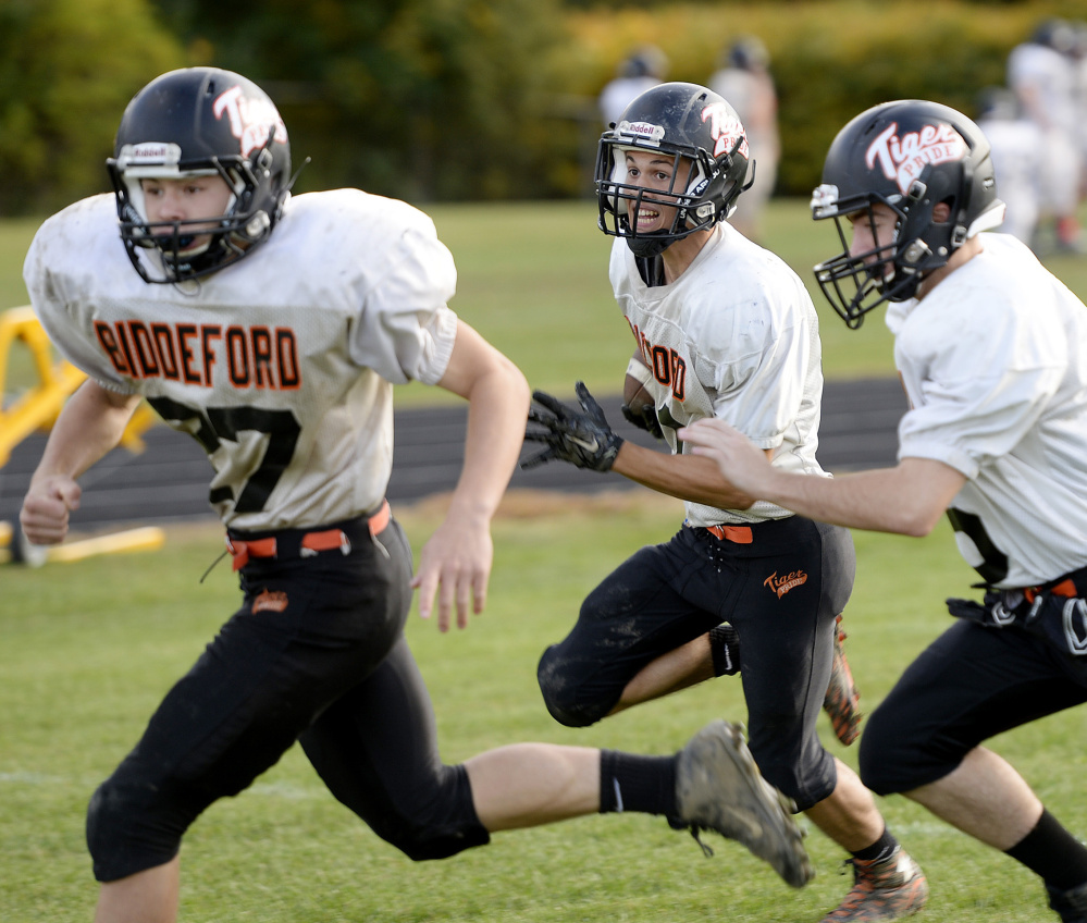 Kickoff and punt returns make the headlines on special teams, but players practice every facet of the game. For example, Tyler Janelle of Biddeford, center, follows his blockers during a fake punt drill.