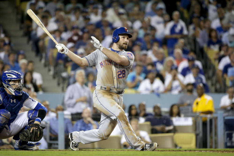 The Mets’ Daniel Murphy watches his home run to right field in the sixth inning. The solo home run turned out to be the game-winner as the Mets beat the Dodgers, 3-2, and advanced to the National League Championship Series.