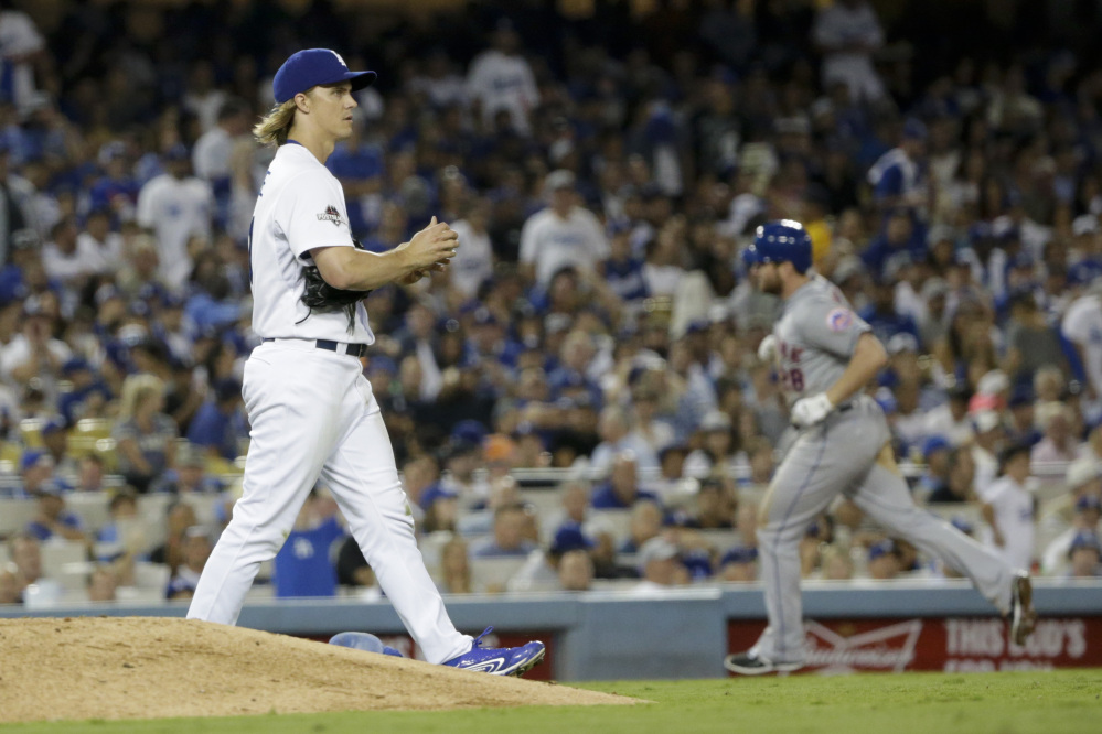 Dodgers starter Zack Greinke looks on after giving up a home run to Daniel Murphy that broke a 2-2 tie in the sixth inning.