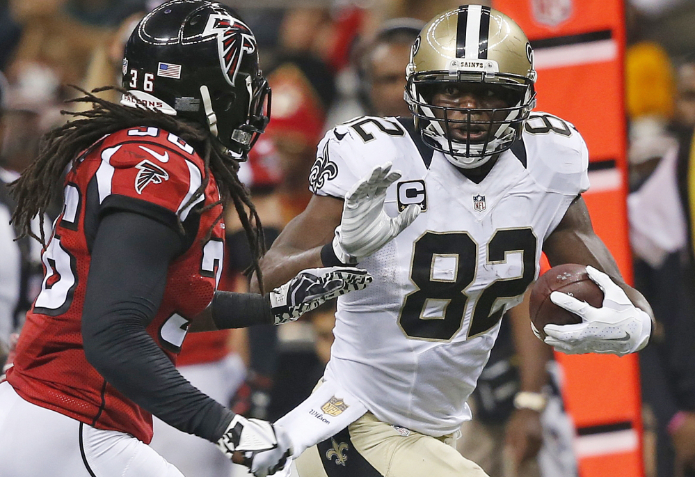Tight end Ben Watson of the New Orleans Saints gains yardage after a first-half reception Thursday night as Kemal Ishmael of the Atlanta Falcons moves in. The Saints held on for a 31-21 win.