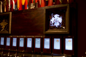 A televised hockey game is reflected in a mirror above the taps on the self-serve beer wall. Gabe Souza/Staff Photographer