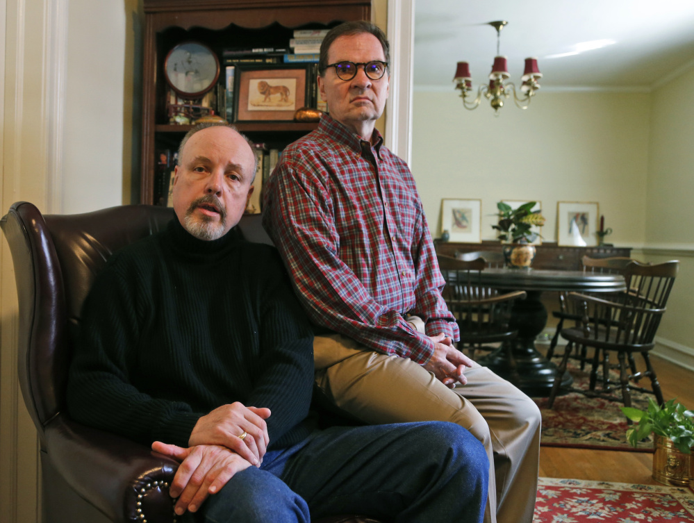 John Murphy, left, who served as executive director of the St. Francis Home, and his husband, Jerry Carter, pose in their home in Richmond, Va. 
The Associated Press