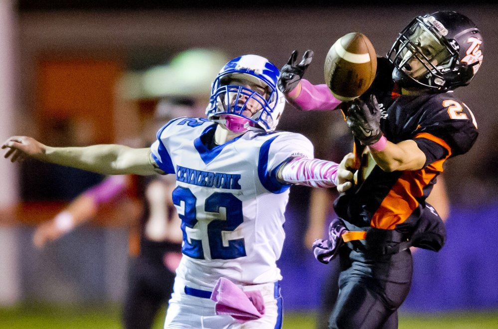 Jesse Lacasse, left, of Kennebunk tries to break up a pass intended for Biddeford’s Tyler Janelle, who almost came up with the catch but couldn’t hold on in the first half Friday night at Waterhouse Field. Biddeford won, 22-8.