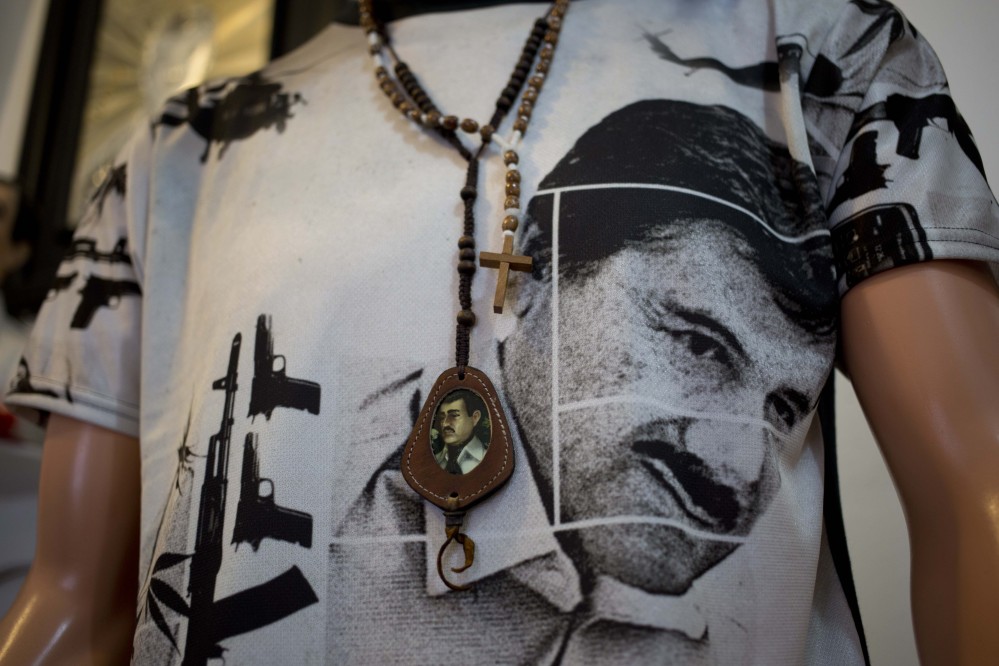 A T-shirt of fugitive Mexican drug lord Joaquin “El Chapo” Guzman covers a mannequin representing Jesus Malverde, known in Mexico as the “Saint” of drug traffickers, inside the shrine of a faith healer in Mexico City.