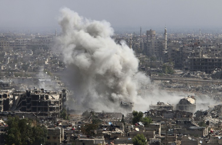 Smoke rises Wednesday after shelling by the Syrian army in Damascus.